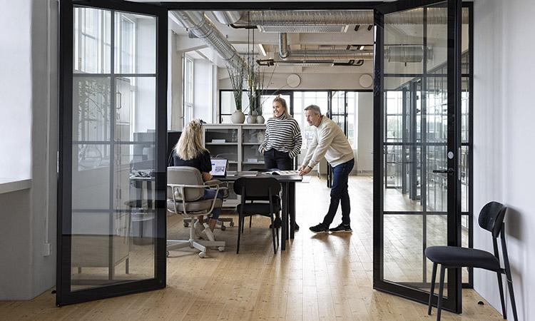Interiör kontorslandskap, tre personer vid skrivbord, Skofabriken Skebäck